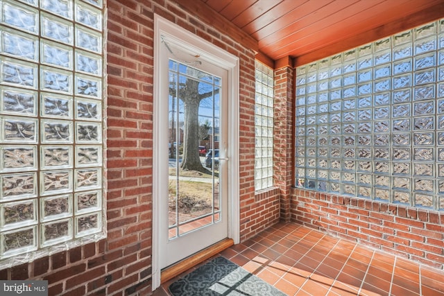 unfurnished sunroom with wooden ceiling