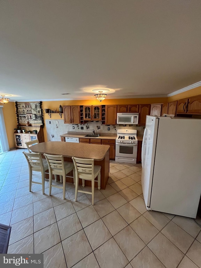 kitchen featuring decorative backsplash, white appliances, sink, and light tile patterned floors