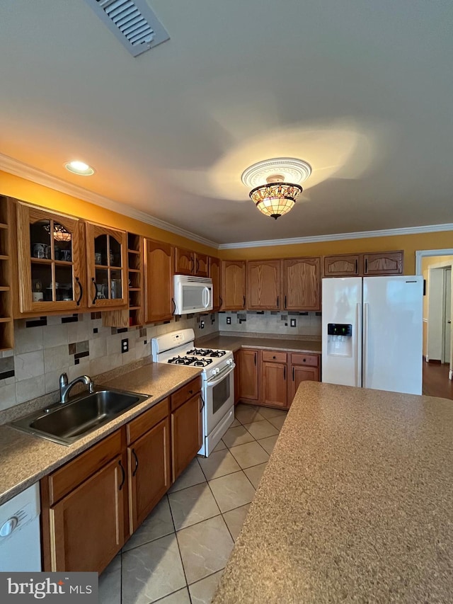 kitchen with sink, backsplash, white appliances, light tile patterned floors, and ornamental molding