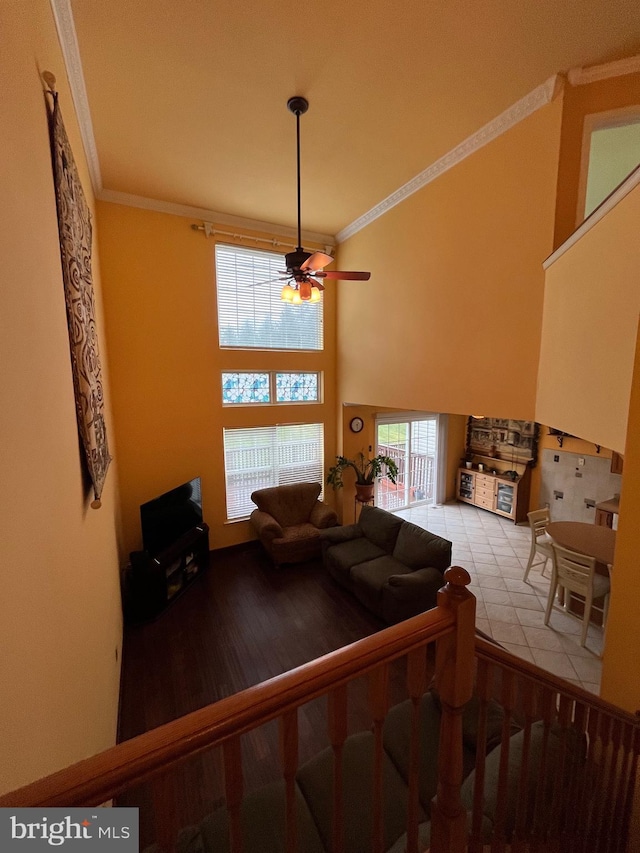 living room with ceiling fan, light wood-type flooring, and ornamental molding