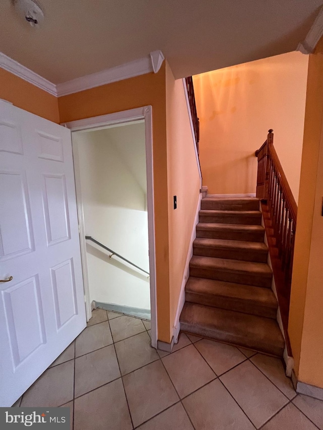 stairs with tile patterned flooring and ornamental molding