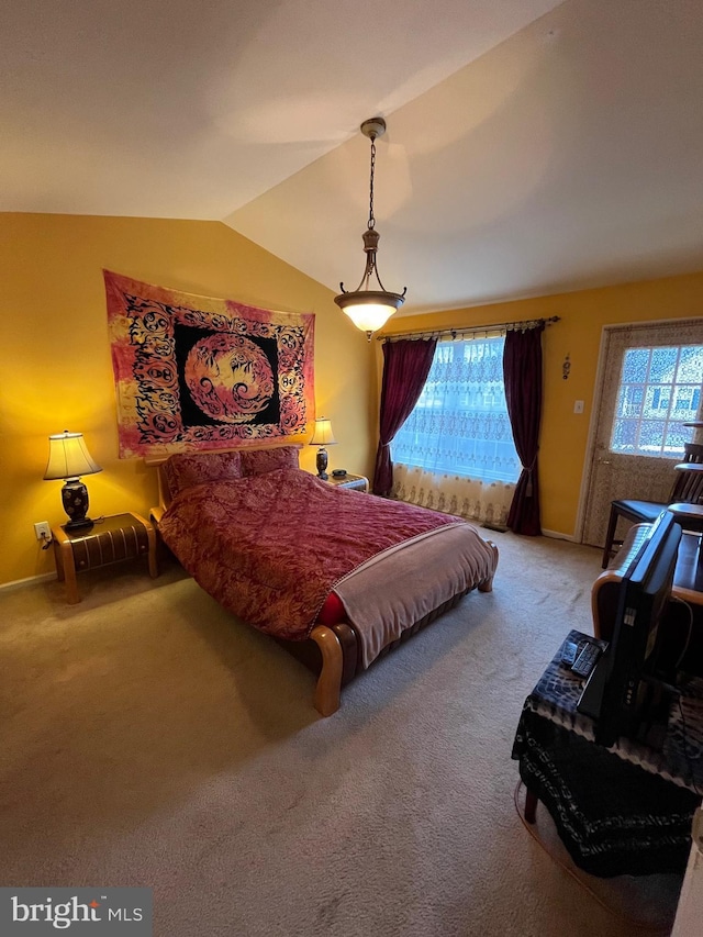 carpeted bedroom with lofted ceiling