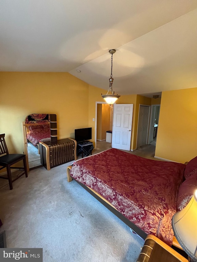 bedroom with carpet flooring and lofted ceiling