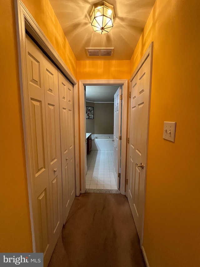 hallway with carpet floors