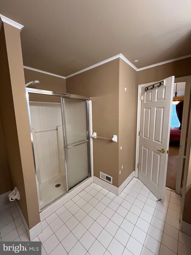 bathroom with tile patterned flooring and crown molding