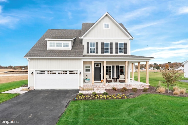 view of front of house with a front lawn, a porch, and a garage