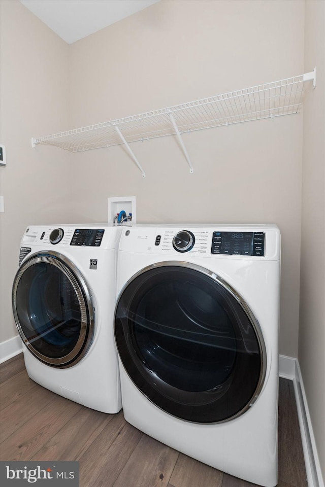 washroom featuring dark hardwood / wood-style flooring and separate washer and dryer