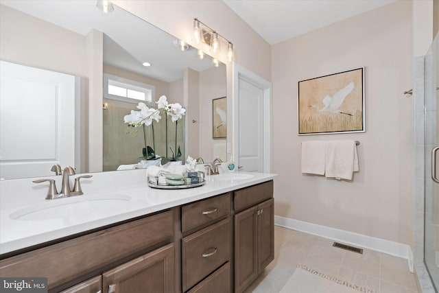 bathroom with tile patterned flooring, vanity, and a shower with shower door