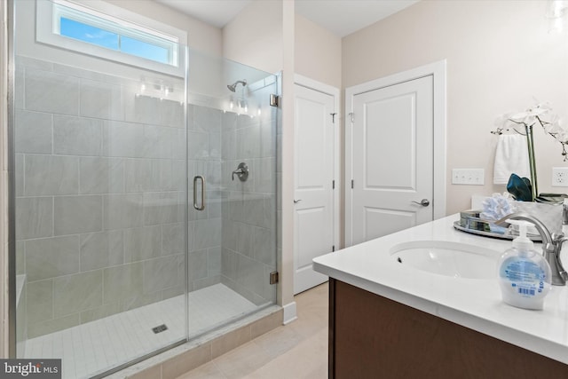 bathroom with tile patterned floors, vanity, and walk in shower