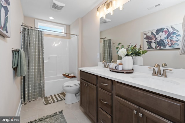 full bathroom featuring tile patterned floors, shower / bath combo with shower curtain, vanity, and toilet