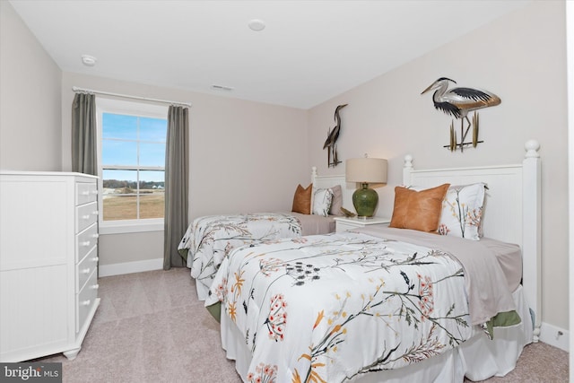 bedroom with light colored carpet