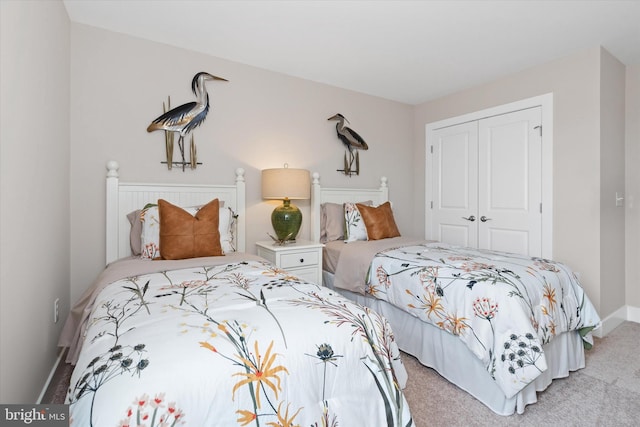 bedroom featuring light carpet and a closet