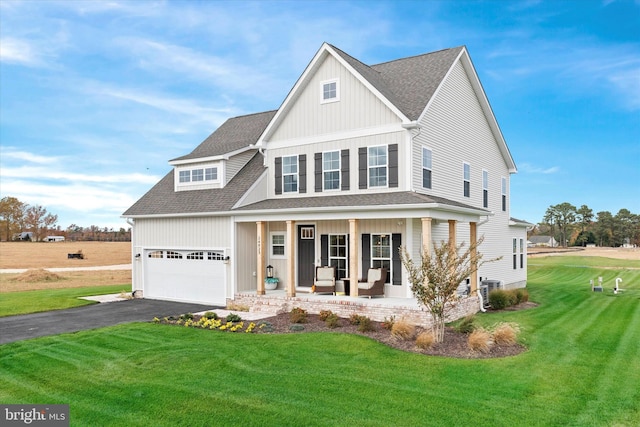 view of front of home with a porch, a front yard, and central AC