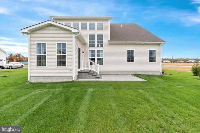 back of house with a patio and a lawn