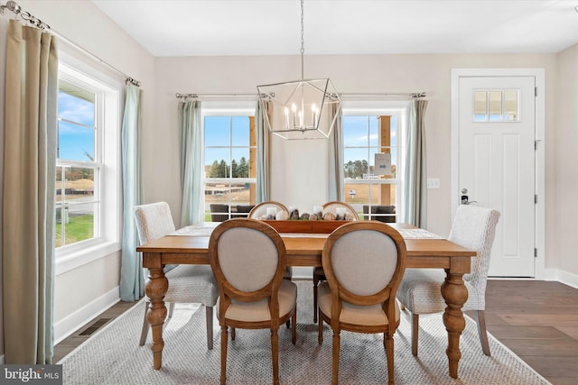 dining room featuring dark hardwood / wood-style floors and a notable chandelier