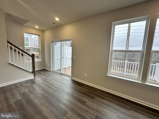 spare room featuring dark wood-type flooring