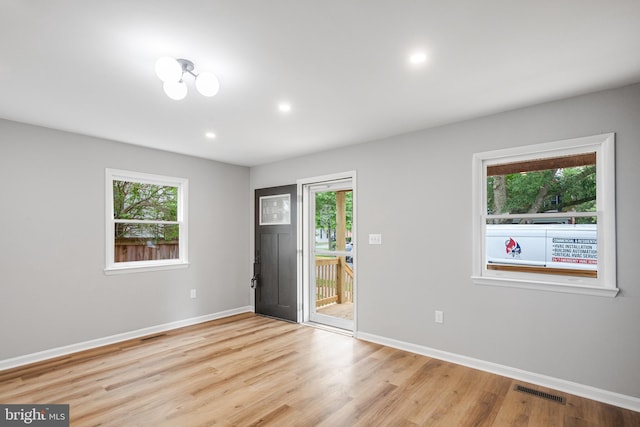 empty room with light hardwood / wood-style floors