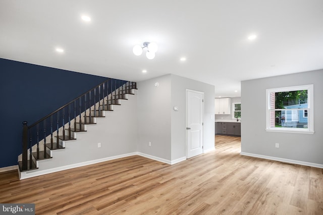 unfurnished living room with light wood-type flooring