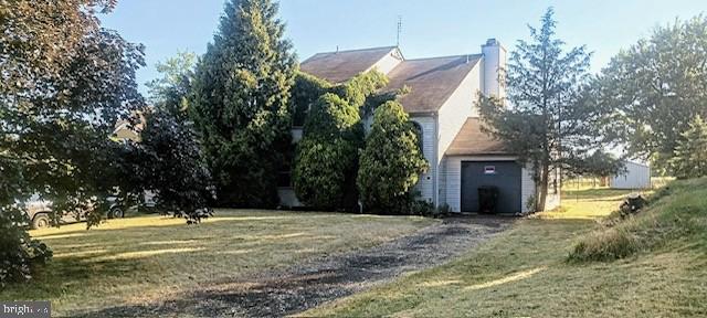 view of home's exterior with a lawn and a garage