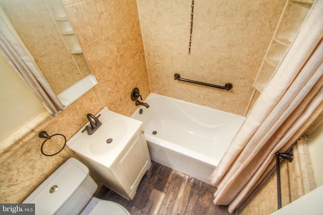 full bathroom featuring toilet, wood-type flooring, sink, and shower / tub combo