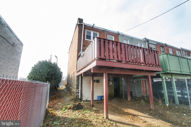 rear view of property with a wooden deck