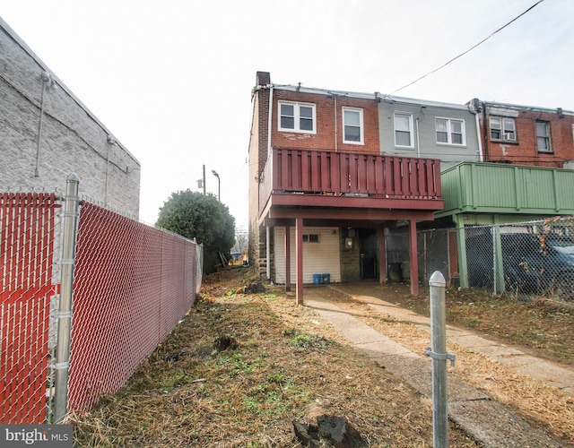 back of house with a wooden deck