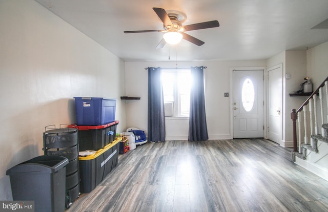 foyer with ceiling fan and dark wood-type flooring