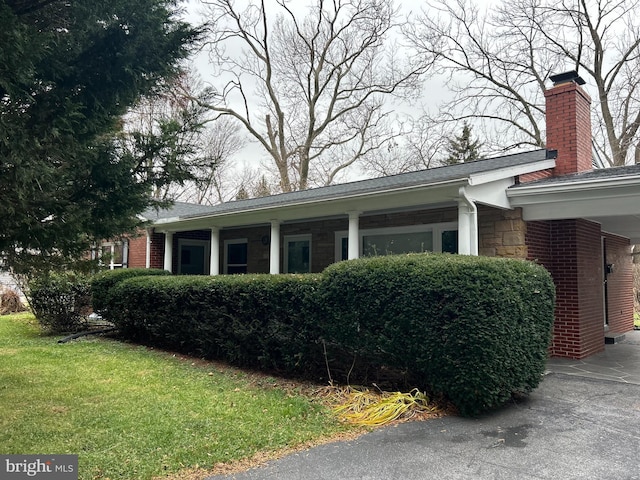 view of side of home with a lawn