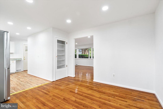 unfurnished room with light hardwood / wood-style flooring