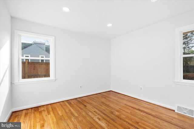 unfurnished room with wood-type flooring