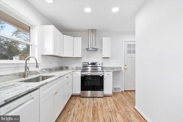 kitchen featuring white dishwasher, sink, wall chimney range hood, electric range, and white cabinetry