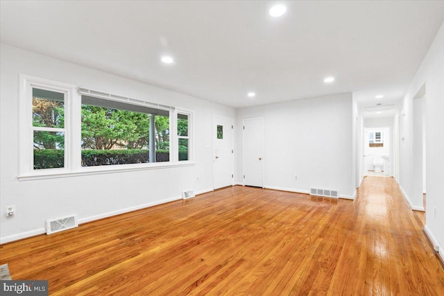 spare room with a healthy amount of sunlight and light wood-type flooring