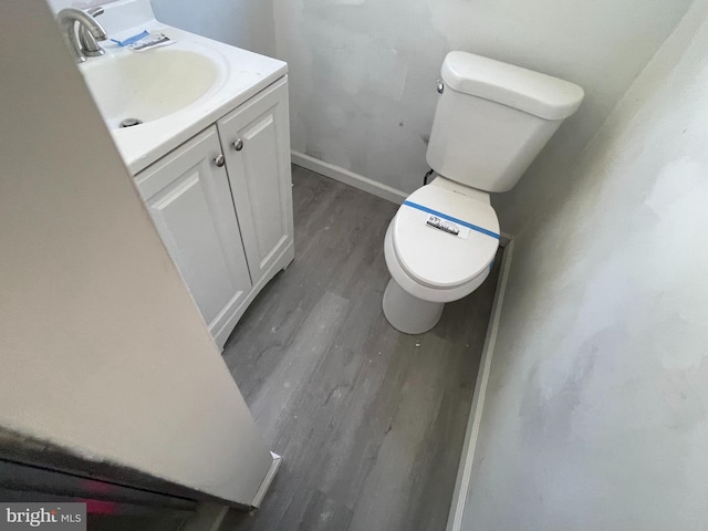 bathroom featuring vanity, toilet, and wood-type flooring