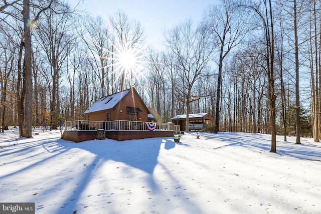 yard layered in snow with a wooden deck