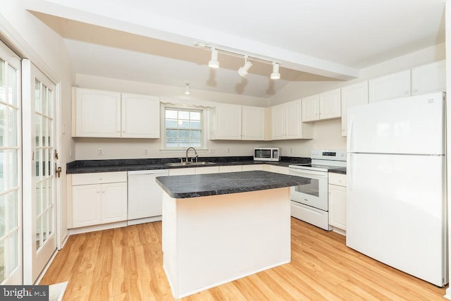 kitchen with white cabinets, light hardwood / wood-style flooring, a kitchen island, and white appliances