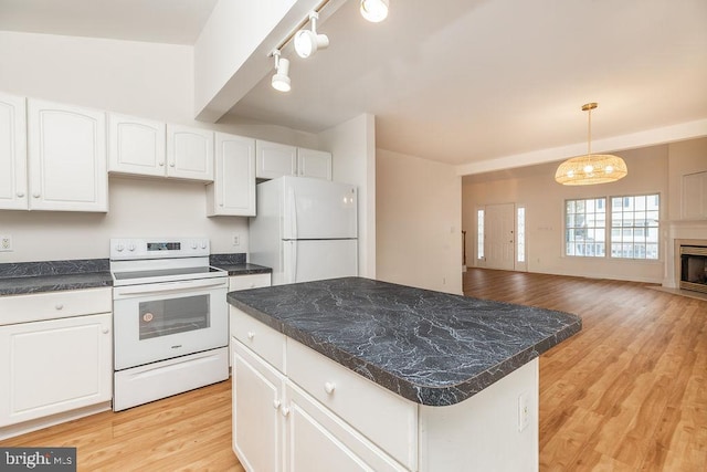 kitchen with white cabinets, a kitchen island, light hardwood / wood-style floors, and white appliances