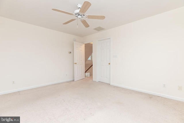 carpeted spare room with ceiling fan