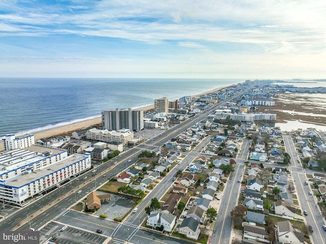 drone / aerial view featuring a water view and a beach view