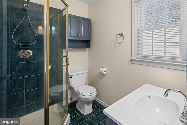 bathroom with tile patterned floors, baseboards, toilet, and a shower stall