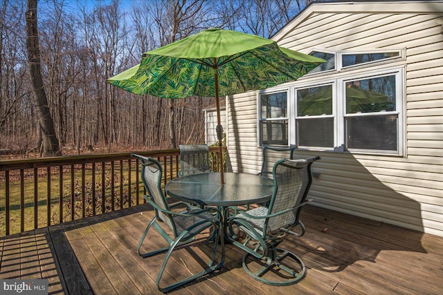 wooden terrace with outdoor dining space