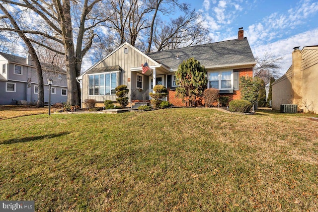 ranch-style home featuring a front yard and central AC