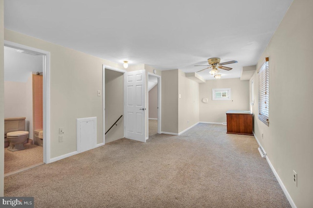 interior space with ceiling fan