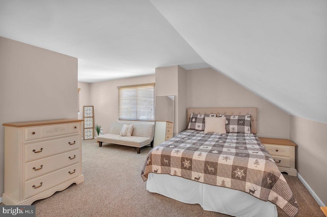 bedroom featuring light carpet and vaulted ceiling