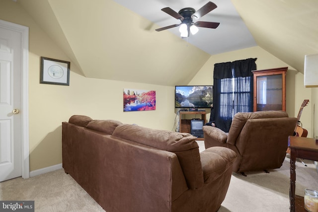 carpeted home theater room with ceiling fan and vaulted ceiling