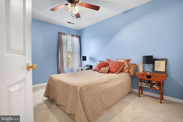 bedroom with ceiling fan and light colored carpet