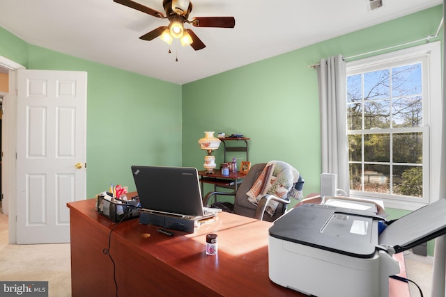 home office with light carpet and ceiling fan