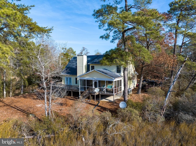 back of house with a deck and a sunroom