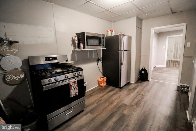 kitchen featuring a drop ceiling, stainless steel appliances, and hardwood / wood-style flooring