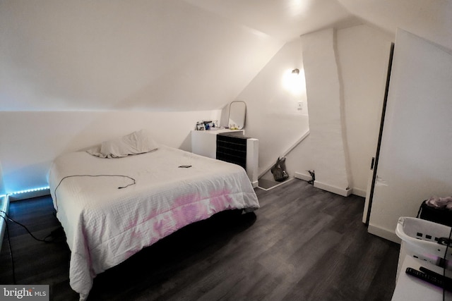 bedroom featuring dark hardwood / wood-style flooring and lofted ceiling