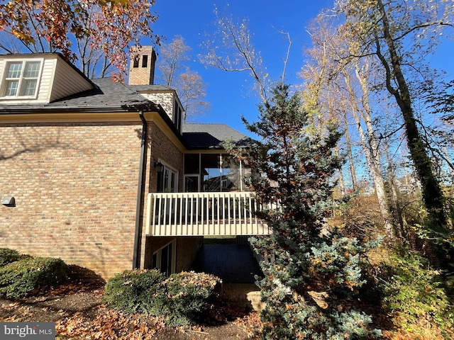 view of side of home featuring a balcony